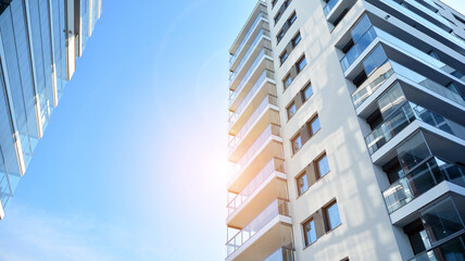 Apartment residential house and home facade architecture and outdoor facilities. Blue sky on the background. Sunlight in sunrise.