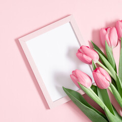 Flowers composition romantic. Flowers pink tulips, photo frame on pastel pink background. Wedding. Birthday. Happy woman's day. Mothers Day. Valentine's Day. Flat lay, top view, copy space