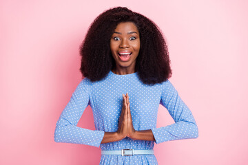 Photo of surprised funny lady hold palms plead open mouth wear blue dotted dress isolated pink...