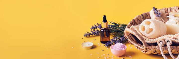 Spa cosmetics products with lavender. Home body skin care. Spa setting on yellow banner