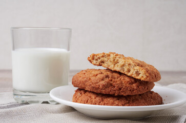 Homemade shortbread kamut cookies with glass of milk on light background