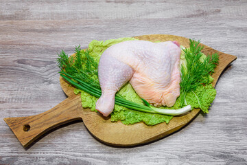 Raw chicken leg. Legs-shaped chicken meat. Chicken is high in protein. Legs, herbs, dill, cabbage...