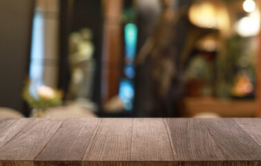 Empty wooden table in front of abstract blurred background of coffee shop . can be used for display or montage your products.Mock up for display of product