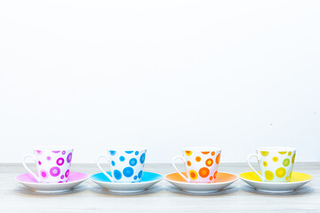 A set of cups. Dishes for coffee. Four coffee cups and saucers are on the table.