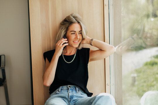 Smiling woman using cell phone
