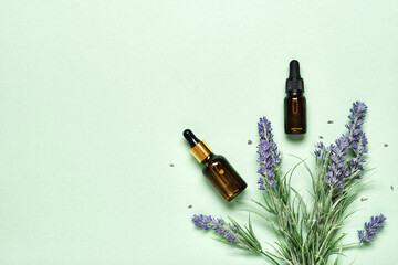 Lavender essential oil on mint green background. Aromatherapy treatment and Skincare spa cosmetics concept