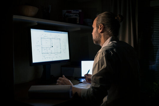 Architect drawing blueprint on computer