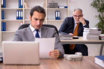 Two employees sitting at workplace