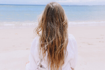 Fototapeta na wymiar young beautiful woman doing meditation on beach