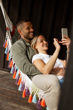 Smiling couple relaxing on hammock
