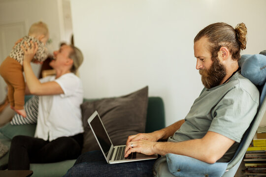 Man sitting on chair and using laptop