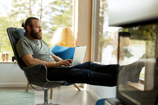 Man sitting on chair and using laptop