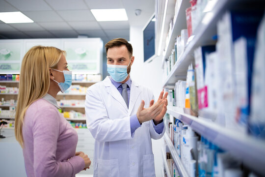 Pharmacist talking to the customer and recommending which medicine to buy.
