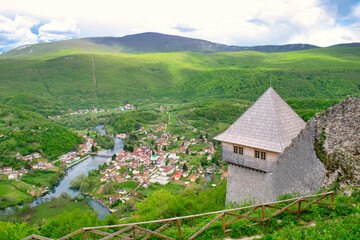 Fototapeta na wymiar The magnificent panoramic view of the mountain valley of Una river and traditional village Kulen Vakuf from the top of ruined castle Ostrovica