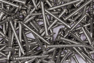 Background of small nails with anti corrosion coating, close-up
