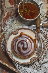 Delicious cinnamon roll buns with cheese glaze served with herbal rtanj tea