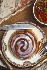 Delicious cinnamon roll buns with cheese glaze served with herbal rtanj tea