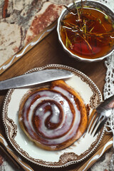Delicious cinnamon roll buns with cheese glaze served with herbal rtanj tea