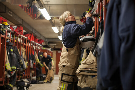 Female firefighter changing clothes in locker