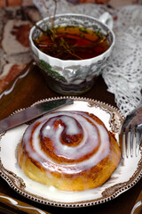Delicious cinnamon roll buns with cheese glaze served with herbal rtanj tea
