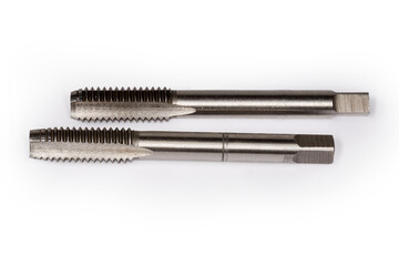 First and second taps for cutting thread on white background