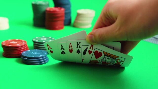 Pocket aces in a deck of playing cards with poker chips. Top view