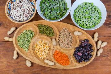 Various dry and frozen legumes, top view on rustic table