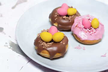 Easter dessert chocolate eggs in the doughnut nest. Holiday food and decoration