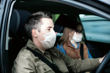 Guy-taxi driver in  white protective medical mask  with woman  sitting in  car