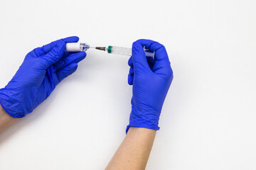 hands in medical blue gloves with a syringe and a vaccine on a white background