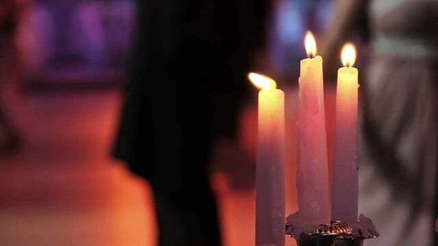 Dancing couples, burning candle and beautiful flowers. Traditional Vienna ball.