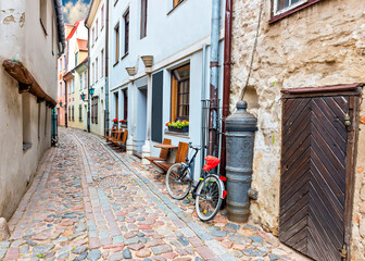 Narrow street in old European town. Walking through medieval streets of old European cities tourists can feel unforgettable atmosphere of the Middle Ages and unique Gothic architecture