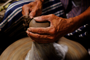 Professional thai old man using mechanic pottery made earthenware at Koh Kret in Nonthaburi Thailand