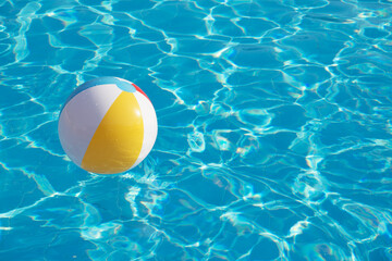 Colorful inflatable ball floating in swimming pool