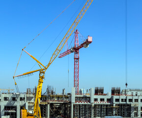 Fototapeta na wymiar Concrete pillars on industrial construction site building of skyscraper with crane.