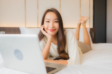 Portrait beautiful young asian woman use laptop on bed