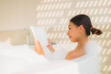 Obraz na płótnie Canvas Portrait young asian woman read book in bathtub