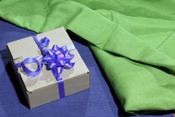 Gift wrap made of paper with a blue ribbon.