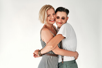 Lesbian couple embracing each other on white background.