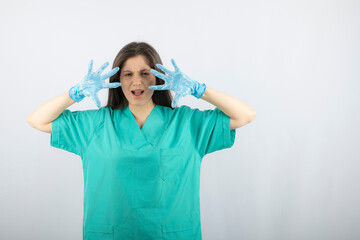 Portrait of a irritated nurse or doctor in green uniform posing