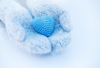 Fototapeta na wymiar Female hands in mittens with heart, close-up