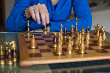 Hand Reaches Out To Make A Move In Chess.
Unrecognizable Person Making A Chess Move With Strategy. Mental Sport