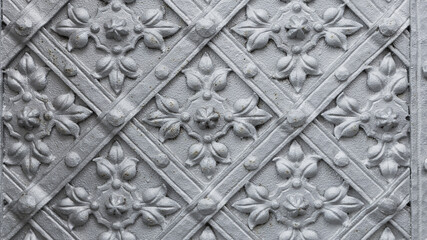 old metal door with cast patterns detail