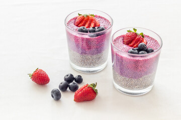 Chia seeds pudding dessert with yogurt and strawberries in glasses