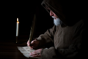 Medieval monk writes a letter - obrazy, fototapety, plakaty