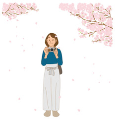 桜の撮影をするカメラ女子