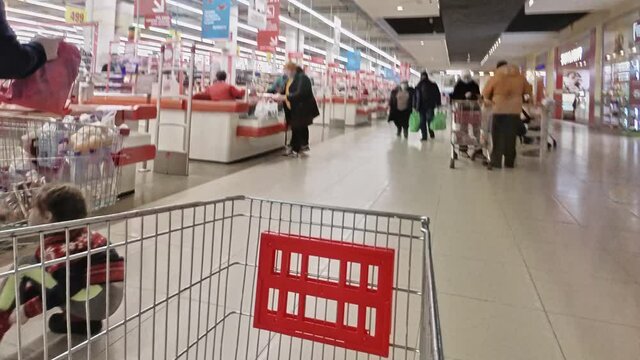 View of the supermarket shopping hall from the shopping cart, time lapse