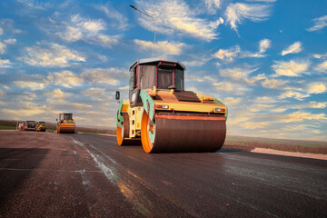 the road rollers working on the new road construction site asphalt compactor