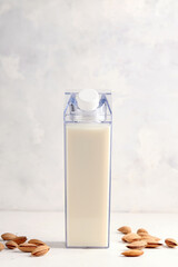 mock up bottles with almond milk on a light background.