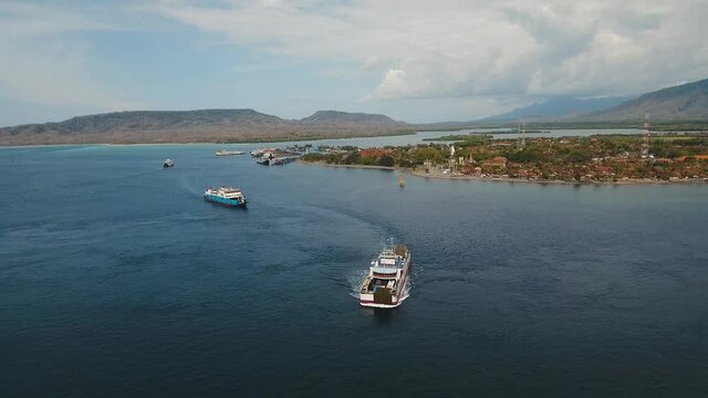 Aerial view ferry port Gilimanuk with ferryboats, vehicles and infrastructure, Bali,Indonesia. Ferries for transport vehicles and passengers in the port. Port for departure from Bali to the island of